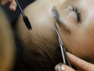 Customer getting eyebrow treatment at a beauty salon