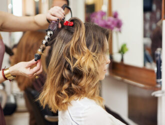 Stylist creating perfect curls at a chic salon
